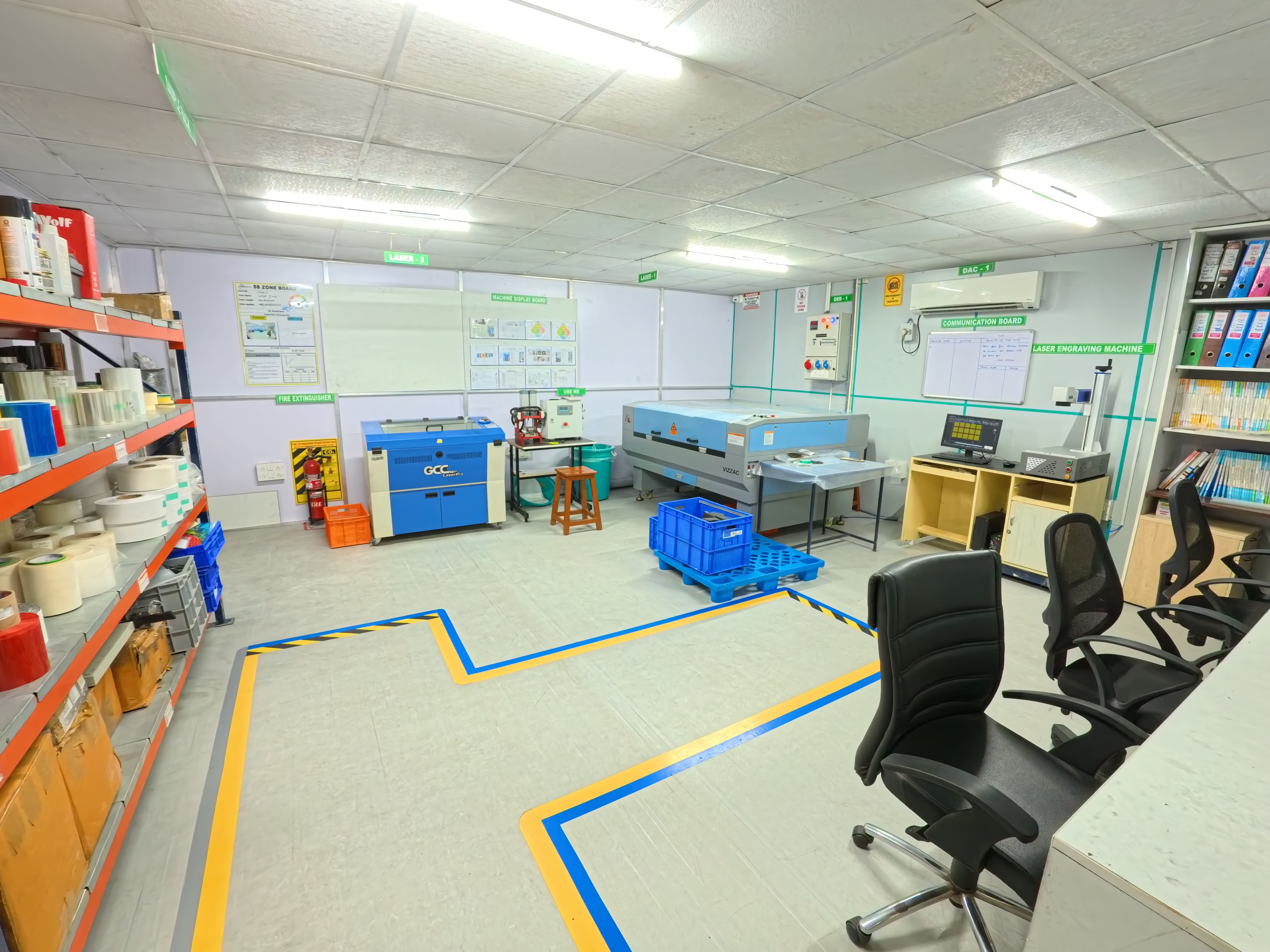 Modern industrial workshop featuring a GCC LaserPro