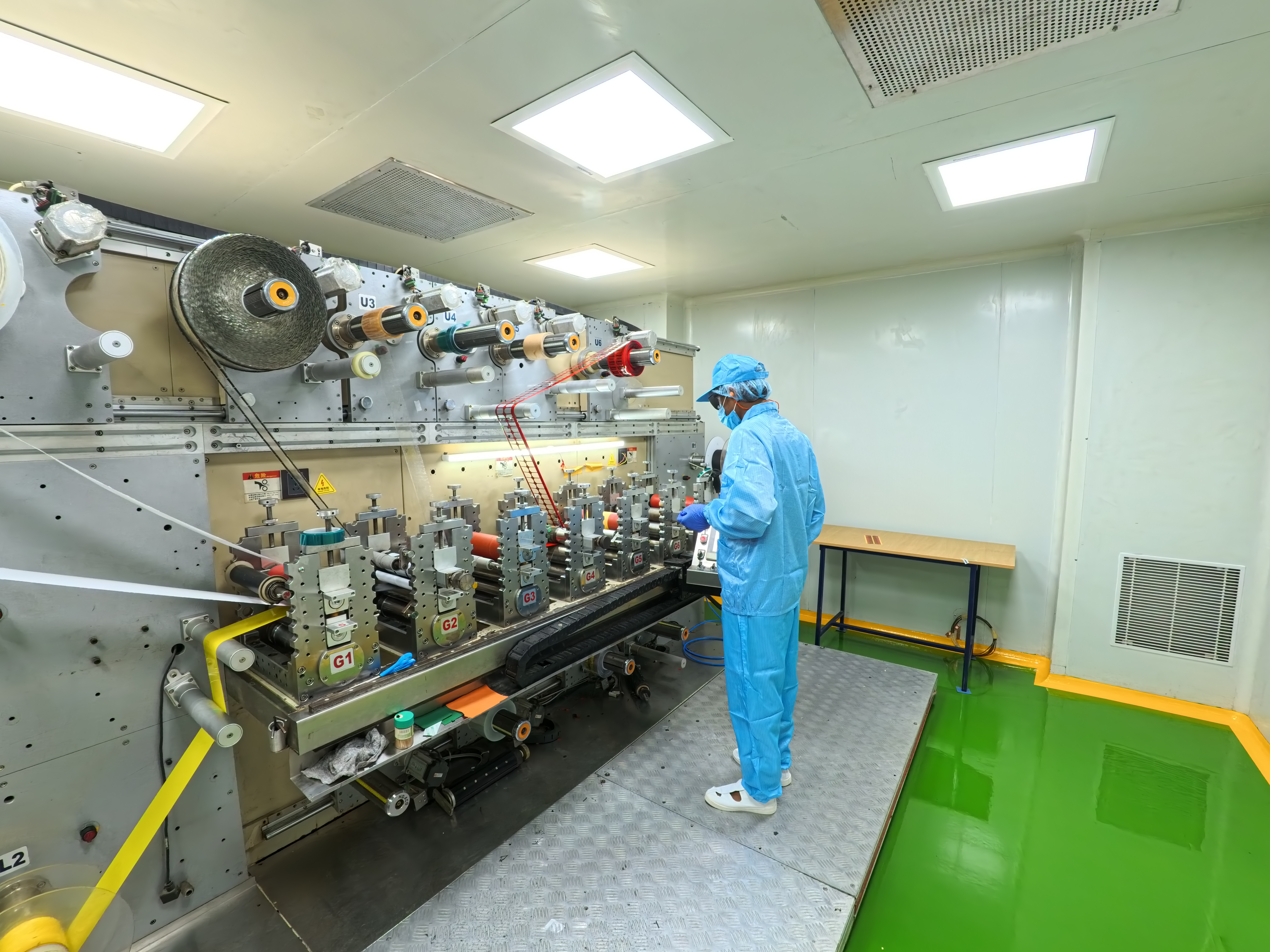 Technician operating a rotary die-cutting machine